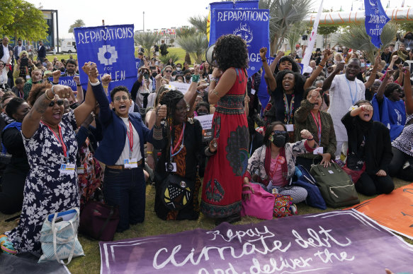 Demonstrators participate in a sit-in calling for reparations for loss and damage at the COP27 UN Climate Summit.