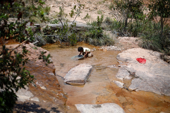 An indigenous child works at a gold mine in the Santa Creuza community in the Raposa Serra do Sol reservation, Roraima state.