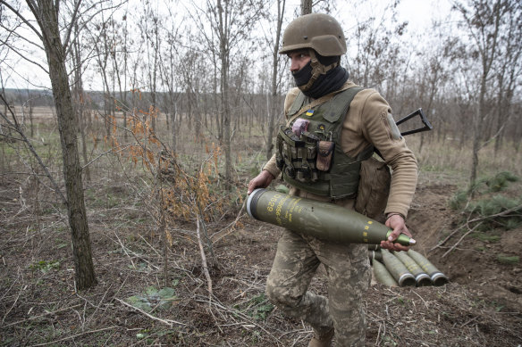 A Ukrainian soldier prepares shells to fire at Russian armoured vehicles outside Kherson.