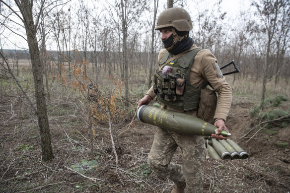 Ukraynalı bir asker, Herson dışındaki Rus zırhlı araçlarına ateş etmek için top mermileri hazırlıyor.