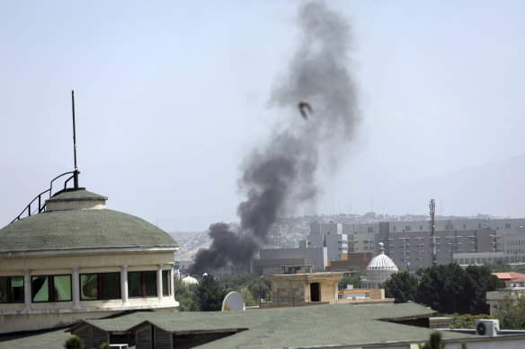 Smoke rises near the US embassy in Kabul on Sunday.