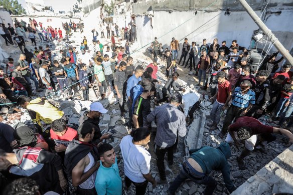 People search buildings destroyed during airstrikes on November 18, 2023 in Khan Yunis, Gaza. 