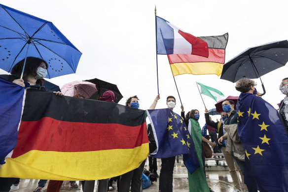 Members of pro-European French and German associations cross the Rhine River bridge that links France and Germany.