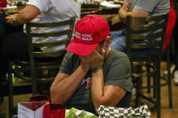 Amy McKinley, a Louisville resident and business owner, reacts during a watch party of the presidential debate.