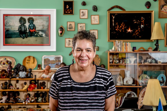 Destiny Deacon inside the NGV exhibition, with some of the ''Koorie kitsch'' she has collection over the years. 