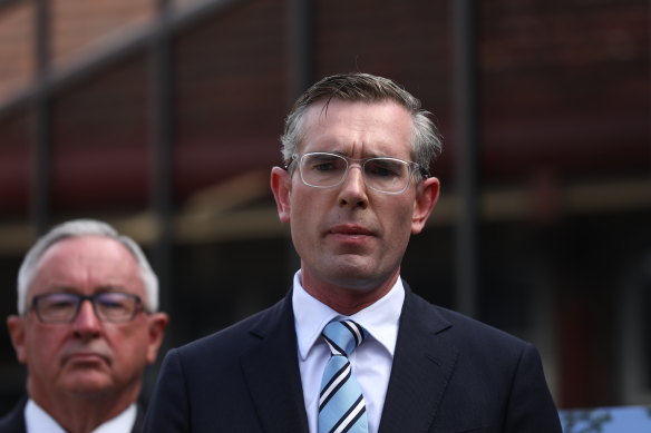 NSW Premier Dominic Perrottet, seen with Health Minister Brad Hazzard, says he has his party’s support despite wearing a Nazi costume in his 20s.