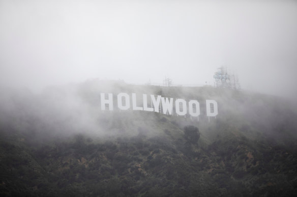 The Hollywood sign is seen through a mix of fog and dust snow during a rare cold winter storm in the Los Angeles area of California on Friday.