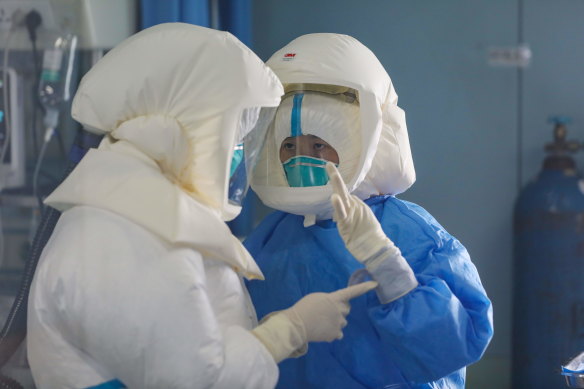 Medical staff working in the negative-pressure isolation ward in Jinyintan Hospital, designated for critical COVID-19 patients, in Wuhan, in February 2020. 
