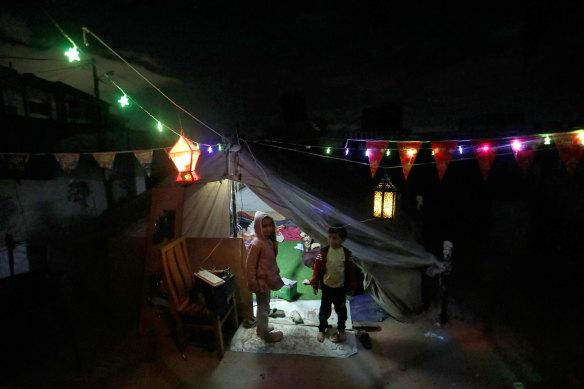  Displaced Palestinians decorate their tent in preparation for the holy month of Ramadan in Rafah, Gaza. 