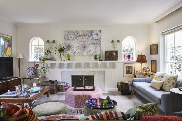 “The architect’s designs involved a Hollywood-inspired use of chandeliers and neoclassical fireplaces,” says Katie. The artwork above the fireplace, Float, is by her.