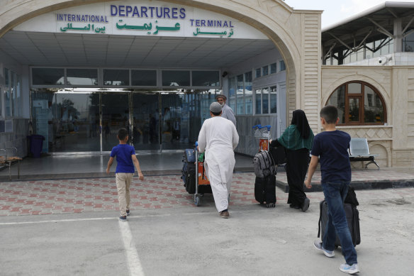 Passengers enter the departures terminal of Hamid Karzai International Airport, in Kabul, Afghanistan, Saturday, August 14, 2021. 
