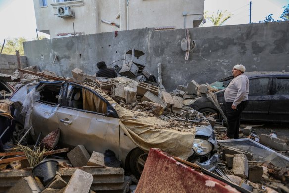 People inspect damage caused to their homes following Israeli air strikes in Rafah, Gaza.