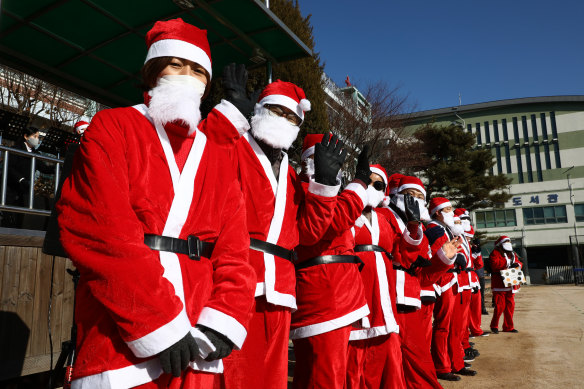 Gathering of more than four people are banned over Christmas and New Year holidays in Seoul. Pictured: South Korean Christian Santas get ready for drive-in religious service. 