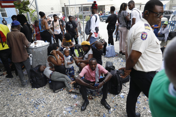 Haitians waiting to board a flight to Nicaragua gather at Toussaint Louverture International Airport in Port-au-Prince, Haiti after the government banned all charter flights to Nicaragua.