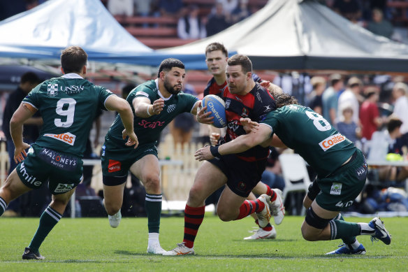 Harry Burey carts the ball into traffic for Norths.