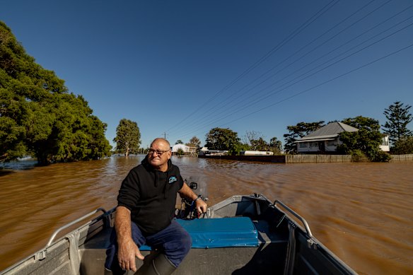Local resident Steve Bacon, whose house is surrounded by water, takes his boat to the pub.