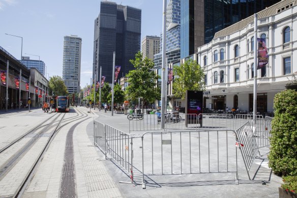 Fencing around the area where the kiosk was removed. 