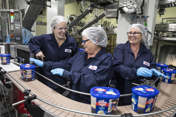 Jessica Anderson, Julie Higgins and Karen Revell churn out ice-cream at Norco’s rebuilt factory in Lismore on Thursday.