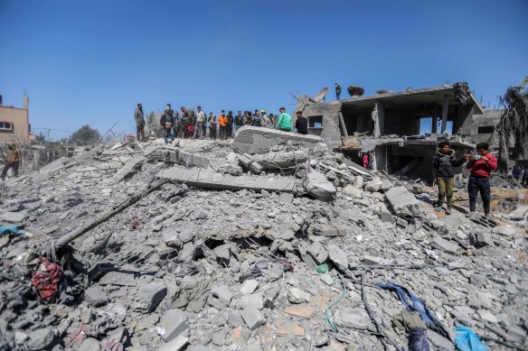 Palestinians inspect the damage following Israeli airstrikes in Rafah last month.