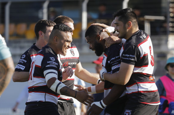 West Harbour players celebrate a try against Newcastle in the Shute Shield.