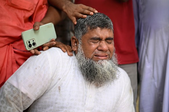 The father of a missing girl cries at the scene.