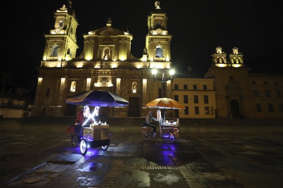 Street vendors leave Bolivar Square at the start of an official continuous multi-day curfew in an effort to contain the spread of coronavirus infections, in Bogota, Colombia on Friday.