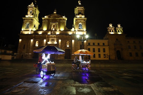 Street vendors leave Bolivar Square at the start of an official continuous multi-day curfew in an effort to contain the spread of coronavirus infections, in Bogota, Colombia on Friday.