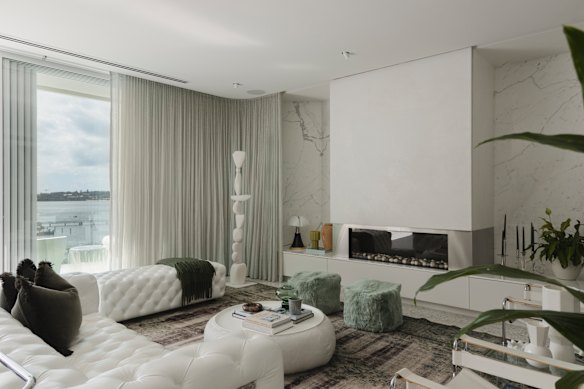 There is a custom pivot door as well as terrazzo floors, expansive glass, a full-height marble feature wall, designer lighting and curved surfaces. 