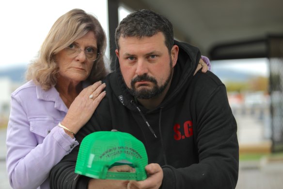 Grandmother Ruth and father Luke Pendergast holding a replica of Baylen’s favourite cap.