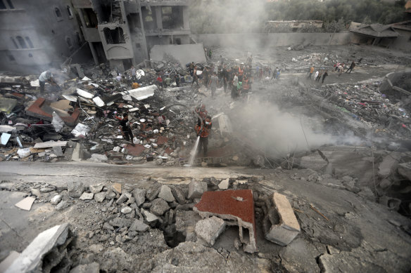 Palestinians look for survivors under the rubble of a destroyed building following Israeli airstrikes in Nusseirat refugee camp, central Gaza Strip.