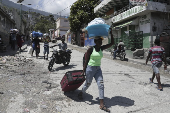Residents flee their homes to escape clashes between armed gangs in Port-au-Prince, Haiti last week.