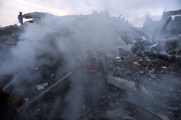 Palestinians look for survivors under the rubble of a destroyed building following Israeli airstrikes in Nuseirat refugee camp.