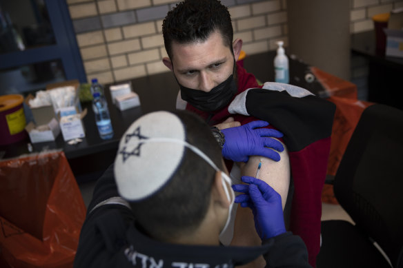 Israeli medical teams administer the Pfizer-BioNTech COVID-19 vaccine to Palestinians at the Qalandia checkpoint between the West Bank city of Ramallah and Jerusalem this week.