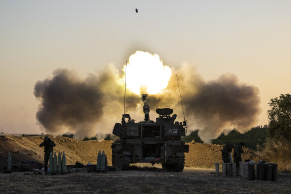An Israeli artillery unit fires shells towards targets in Gaza Strip, at the Israeli Gaza border. 