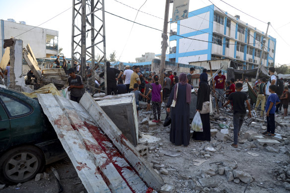 Blood can be seen in the aftermath of the Israeli airstrike the a UN-run school.