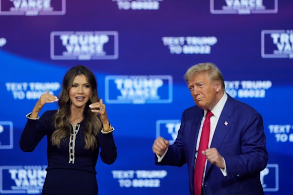 Donald Trump and Kristi Noem dance to the song YMCA at a campaign town hall in Philadelphia.