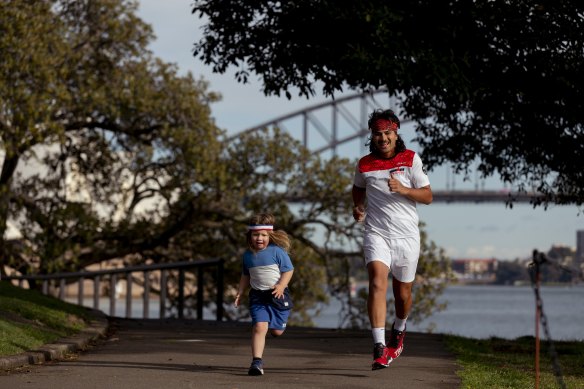 Marathon runner Christian Gillies, seen with his son Minolo, will run his 100th marathon on Sunday.