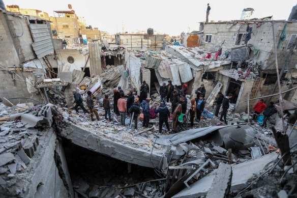 People inspect the damage to their homes following Israeli air strikes  on Rafah on Monday.