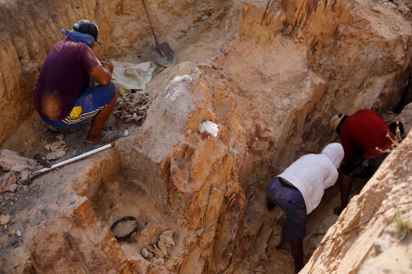Indigenous people work in a gold mine at the Napoleao community in the Raposa do Sol reservation.