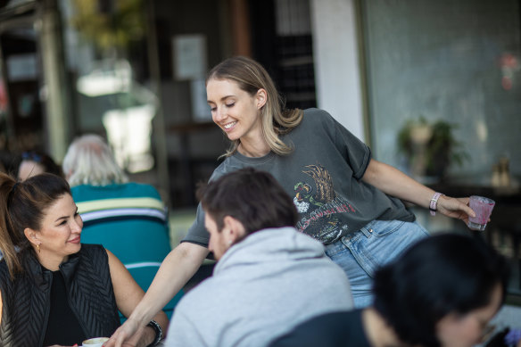 Bec Moore, owner of café Tinker on High Street, Northcote, delivers a coffee with a “hospo smile”.