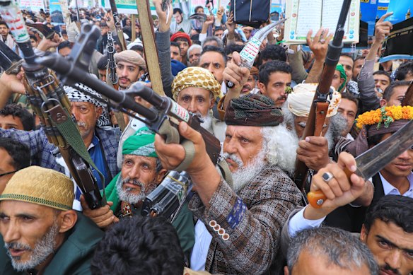 Supporters of Yemen’s Houthi rebels raise their rifles during a rally in September.