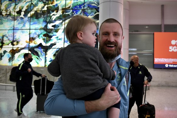 Andrew Redmayne is greeted by his daughter Poppy at the airport.