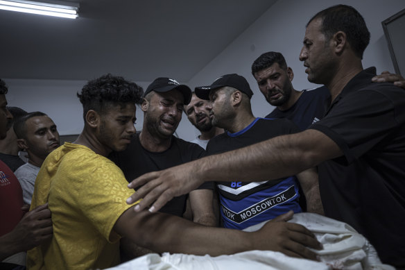 Relatives of Palestinian Noor Al Zubaidi, who was killed during an israeli airstrike in Beit Hanoun north of Gaza City, react during his funeral at Al shifa hospital in Gaza City.
