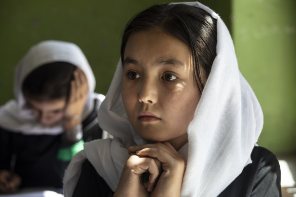 Behishta, 11, listens during 4th grade class at the Zarghoona high school for girls in Kabul. There is widespread fear the Taliban will reintroduce its notorious system barring girls and women from almost all work, and access to education. 