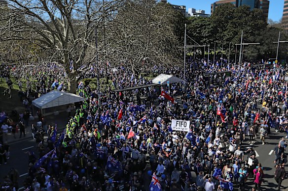 Anti-immigration protesters carry flags and chant as they march towards Victoria Park. 