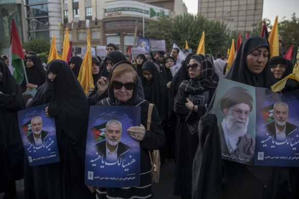 Hundreds of protesting Iranians take part in a protest against the killing of Ismail Haniyeh in Palestine Square in Tehran.