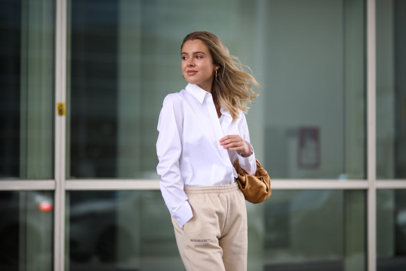 Model Isabelle Schroeder wearing a tailored shirt with joggers.