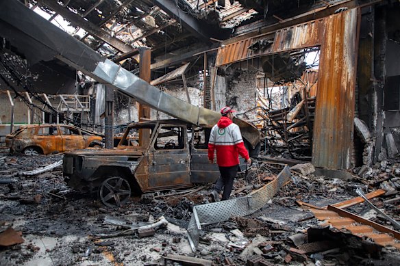 A rescue worker walks through a bombed-out workshop in Tehran on Saturday.