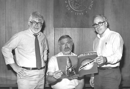 Three former directors of the Global Smallpox Eradication Program, Dr J. Donald Millar, Dr William H. Foege and Dr J. Michael Lane, holding World Health magazine, 1980.