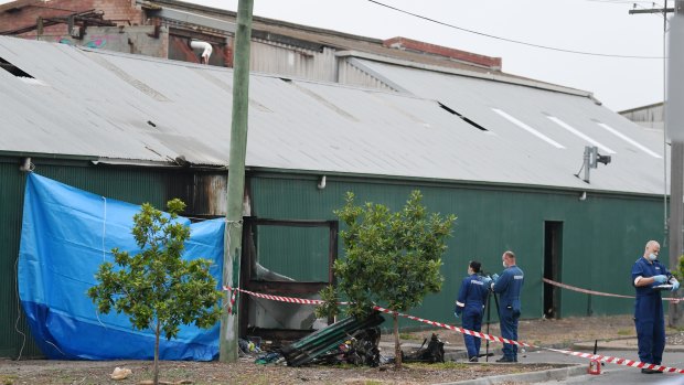 Police and forensic officers comb the scene in the aftermath of the Footscray fire.